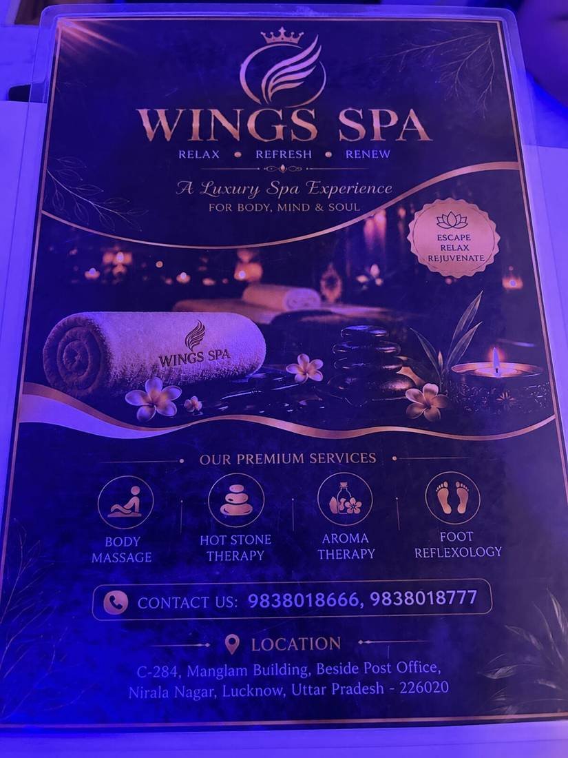 Wings Spa welcome board with services and location